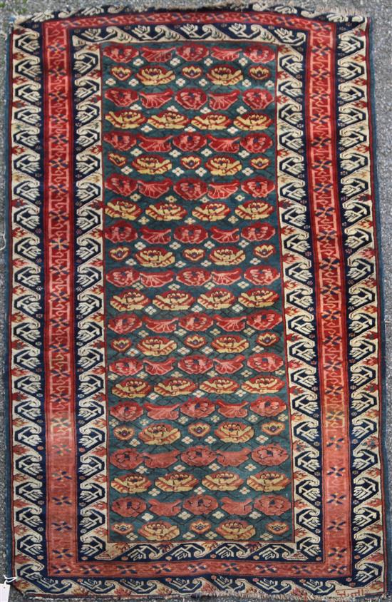 A Turkish rug, 5ft 10in by 3ft 11in.